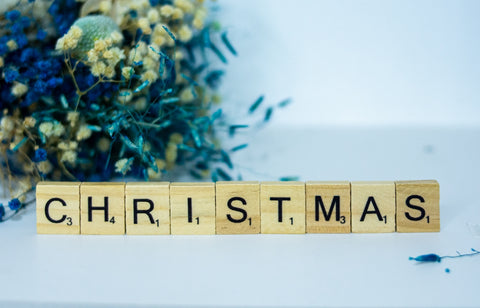 a scrabbled wooden block spelling out the word christmas